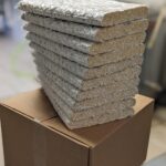 A stack of bulk tempeh in 10 slabs each weighing 2lbs each.